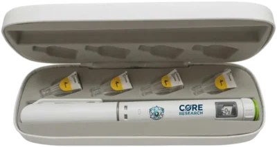 Reusable metal peptide pen with Core Research branding, shown open in its storage case with four pen needle tips, research use only